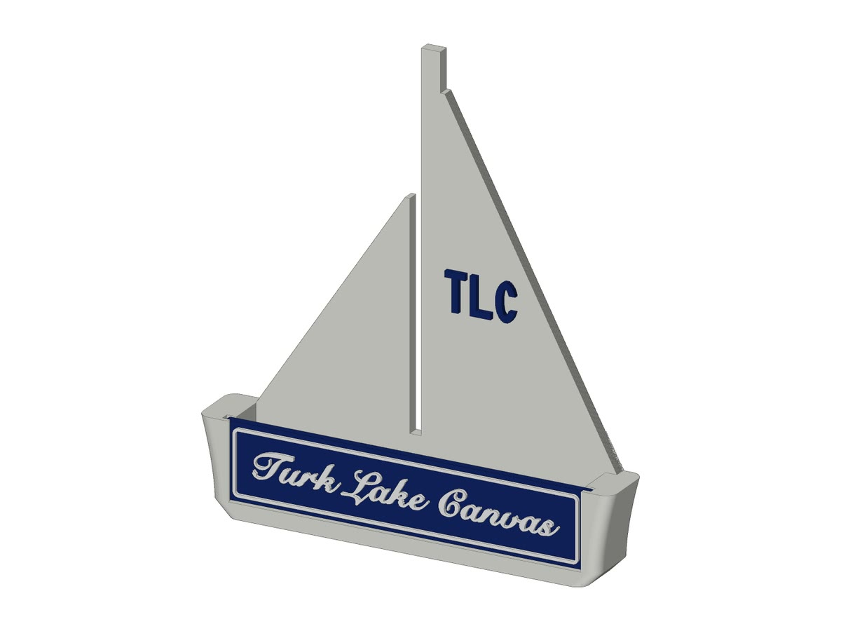 A custom business card holder shaped like a sailboat, with TLC on the sail and Turk Lake Canvas in script on the hull